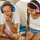 children using wireless headphones and sharing audio adapter