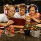 children wearing headphones using sharing cable